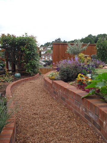 brick retaining wall and raised flower beds